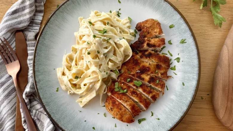 Plate of Ultra Creamy Chicken Fettuccine Alfredo with fresh parsley