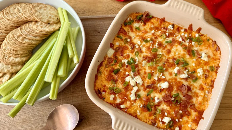 Spicy, creamy buffalo chicken dip served in a white baking dish