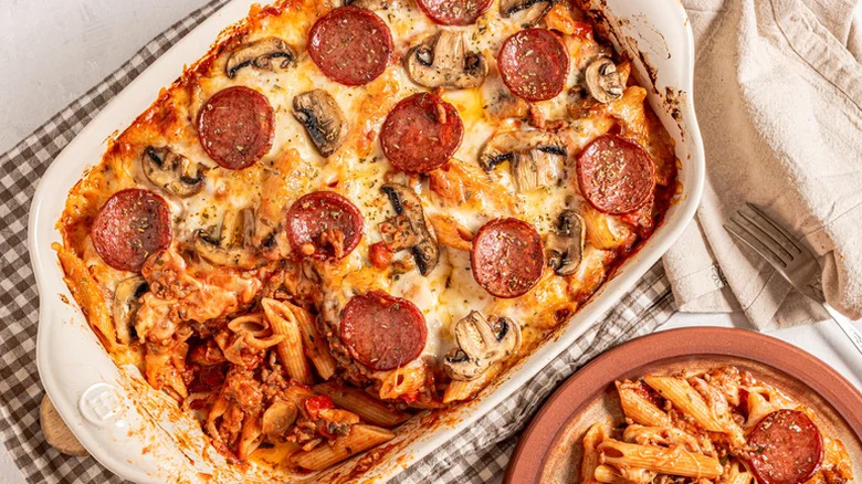 Dish of pasta with pepperoni and a plate