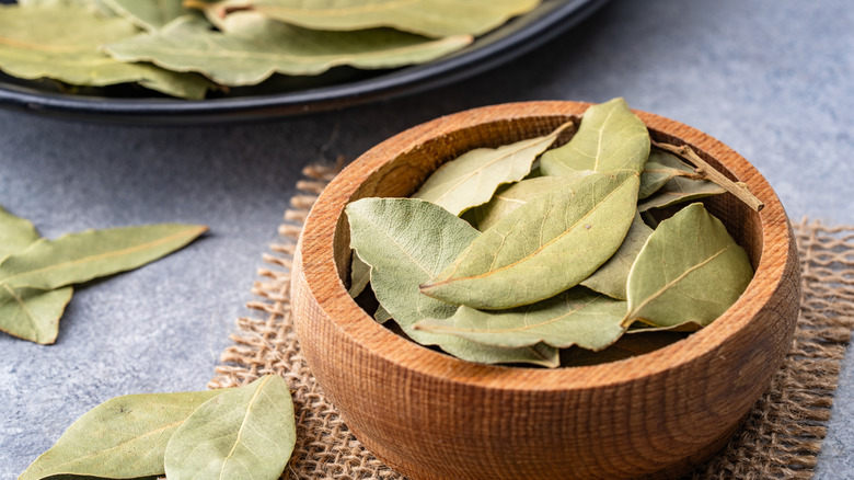 A wooden bowl of bay leaves.