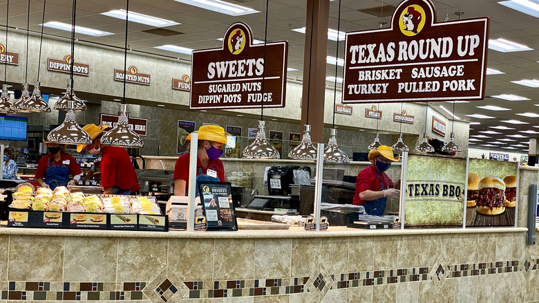 Workers prepare food at Buc-ee's behind the food hall counter