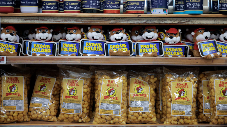 Shelves of Buc-ee's phone holders and Beaver Nuggets