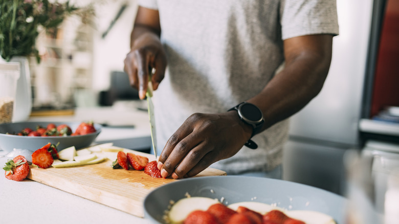 man preparing strawberries