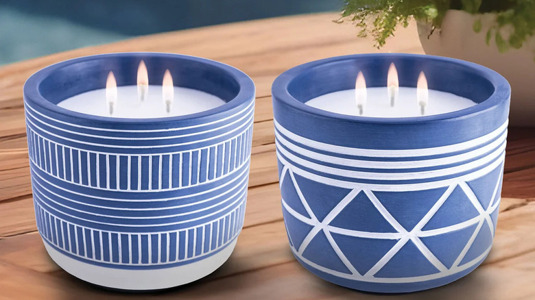 Pair of citronella candles in patterned blue holders