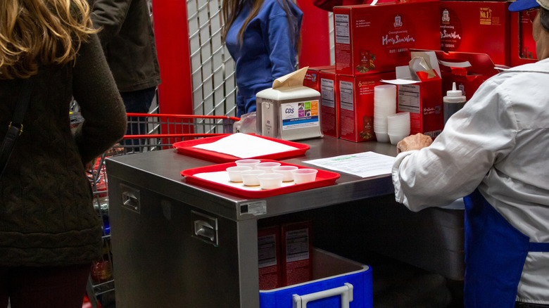 Person handing out free samples inside Costco