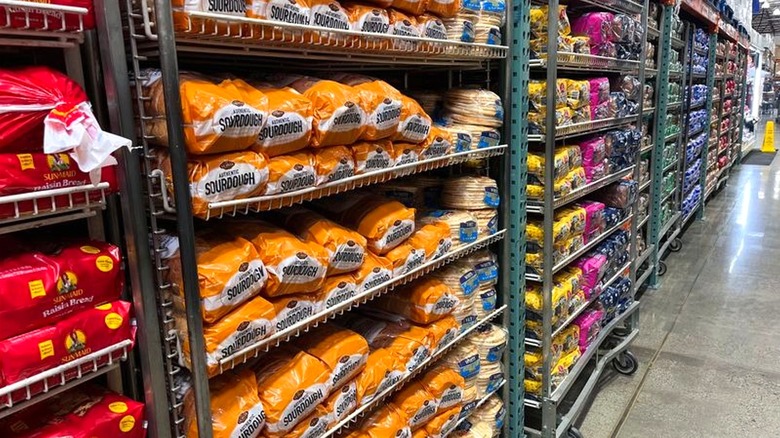 Aisle full of various breads on display inside Costco