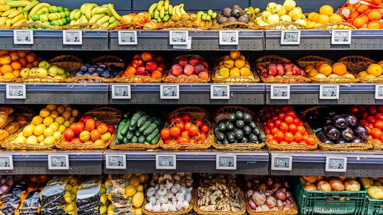 Vegetables and price labels on shelves in produce section