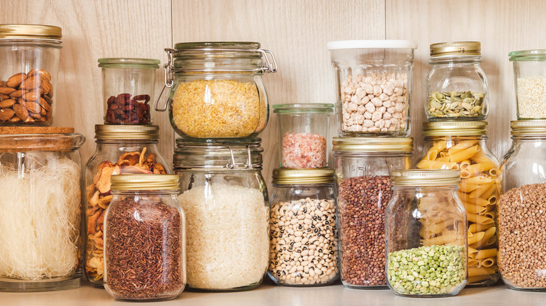 Jars of dry goods sitting on shelves