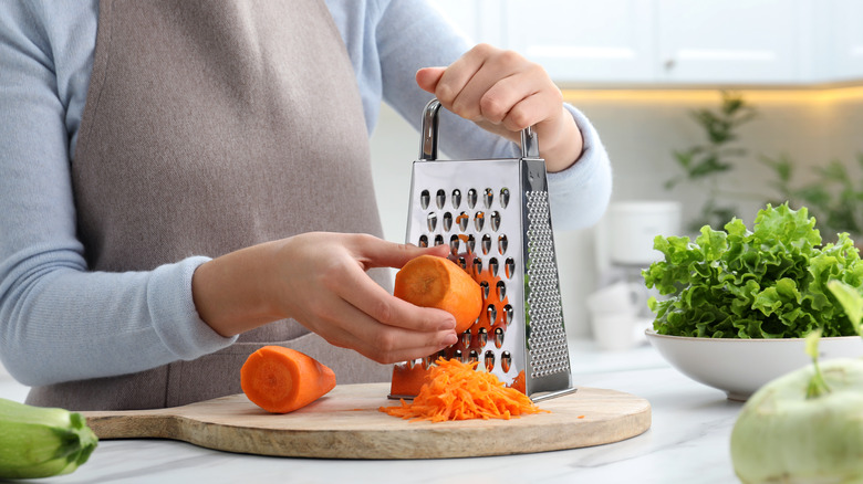 Person grating carrots