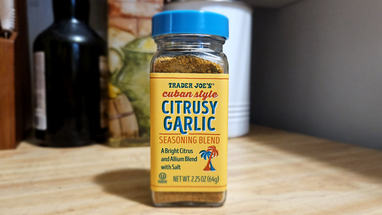 A yellow-and-blue seasoning jar sitting on a kitchen counter