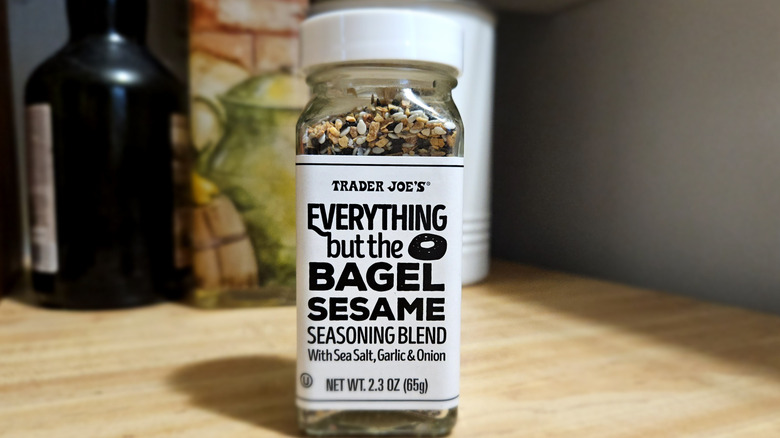 A glass bottle of everything bagel seasoning from Trader Joe's against a kitchen backdrop