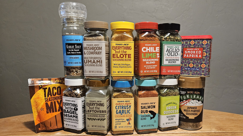 A stack of different Trader Joe's seasonings bottles against a white backdrop