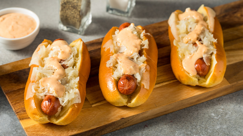 Three hot dogs with sauerkraut