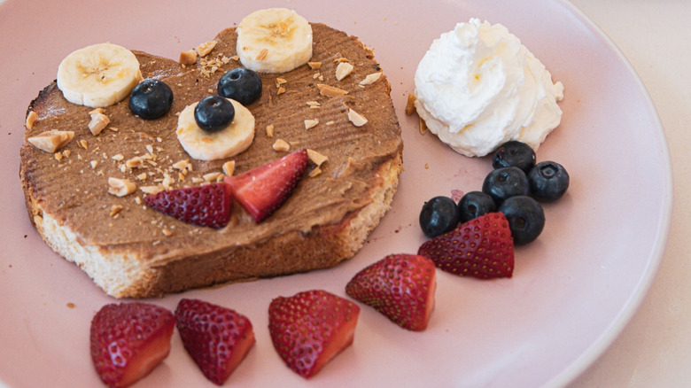 A plate of teddy bear toast with fruit at Café Lola