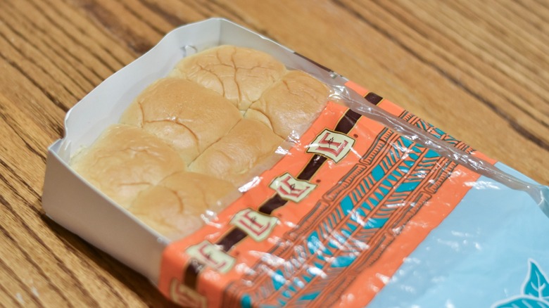 A package of sweet rolls on a wooden table