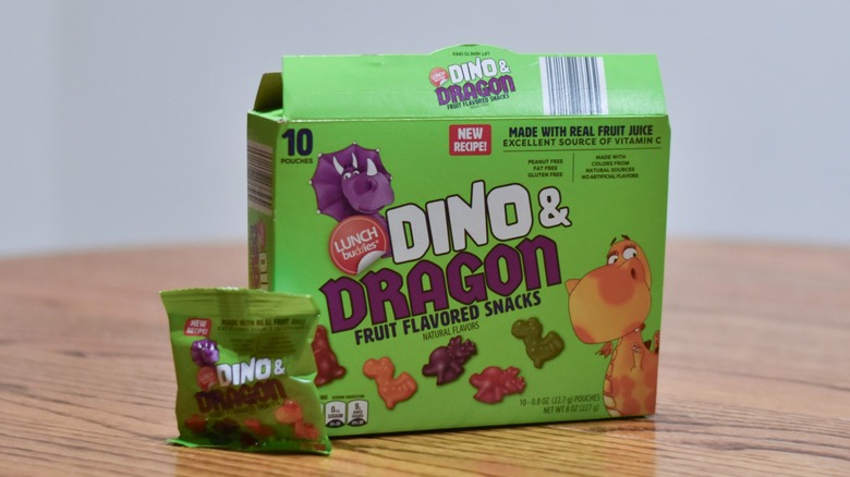 A box of Dino & Dragon fruit flavored snacks on a wooden table