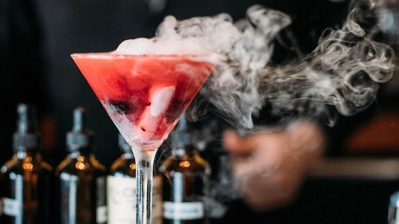 A Berries & Bubbles cocktail wafting dry ice fog at Ocean Prime