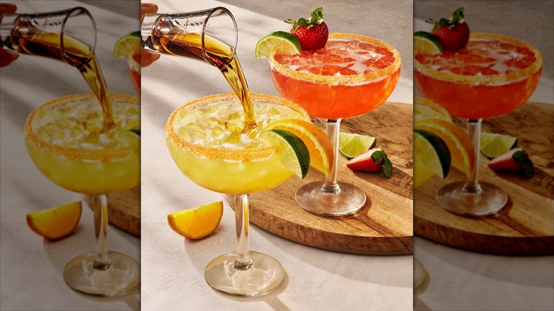 A person pouring a shot into an Italian Margarita at Olive Garden