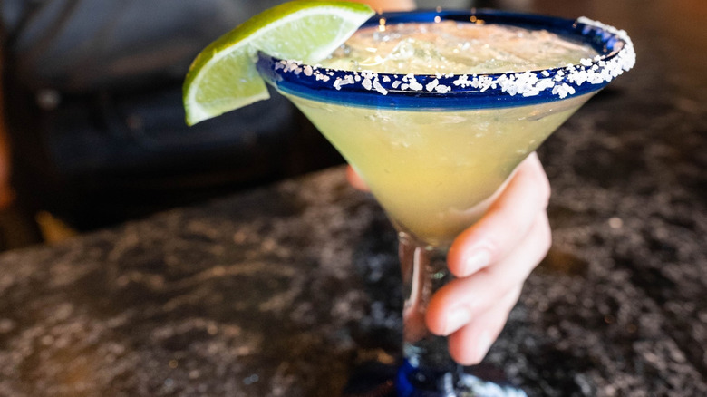 A person holding a Presidente Magarita at Chili's