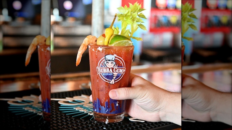 A person holding a Tito's Premium Bloody Mary at Bubba Gump Shrimp