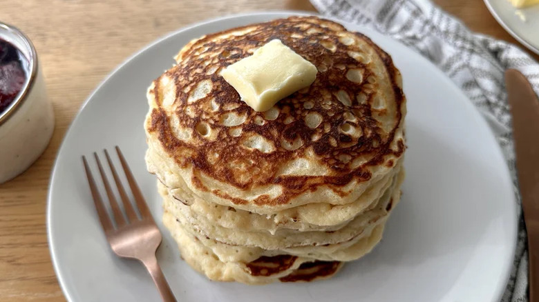 Stack of buttermilk pancakes with a pat of butter on top