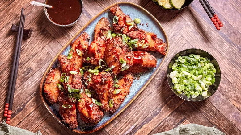 Korean dry-rubbed chicken wings served with scallions and gochujang dipping sauce