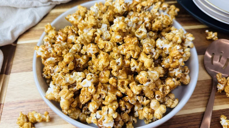 Crunchy caramel popcorn in a white bowl
