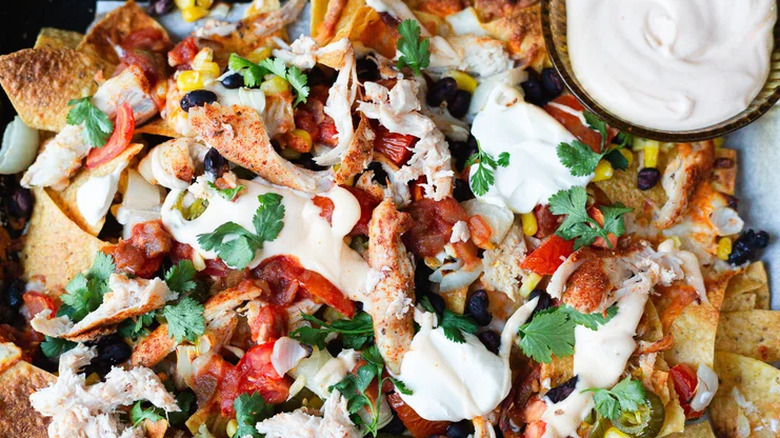 Loaded chicken nachos topped with sour cream
