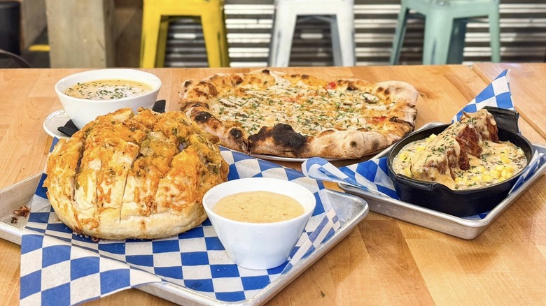 A spread of pizza, cheesy bread, and soup at Mall of America