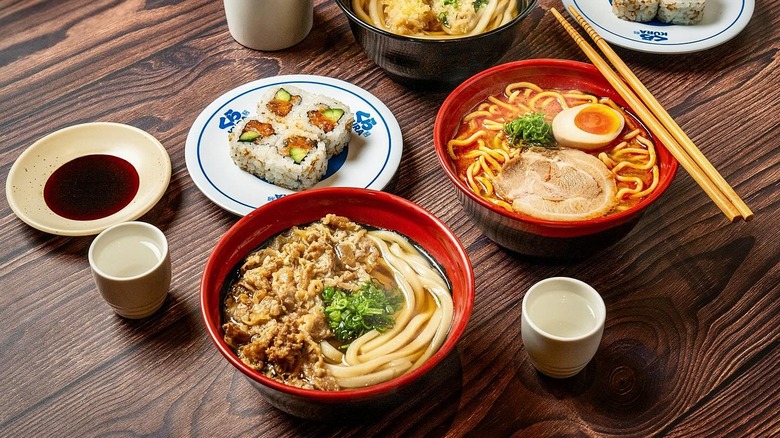 Bowls of Udon noodle soup and sushi on a table at Tangram Mall