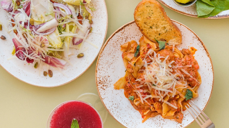 A plate of pasta and a salad at The Grove