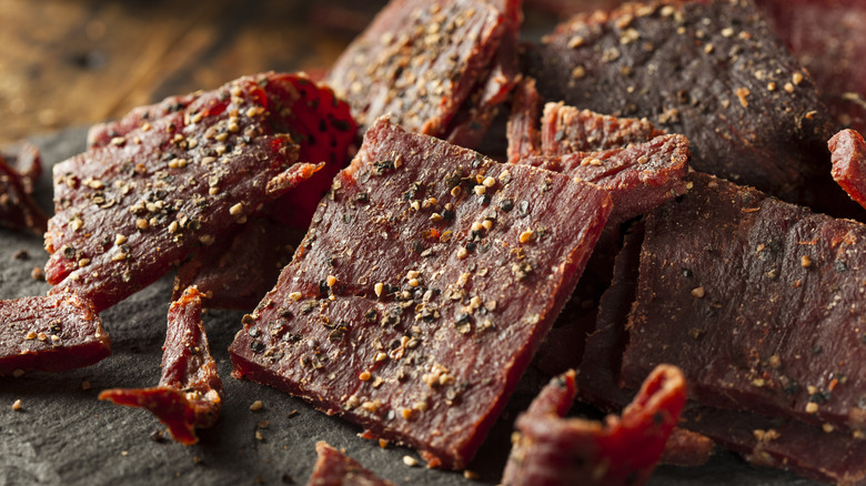 Pieces of dried, peppered beef jerky