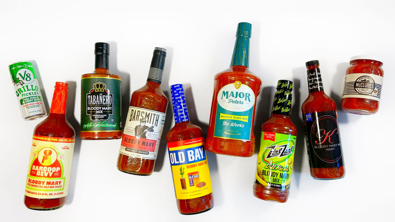 Several brands of Bloody Mary mix arranged on a white background