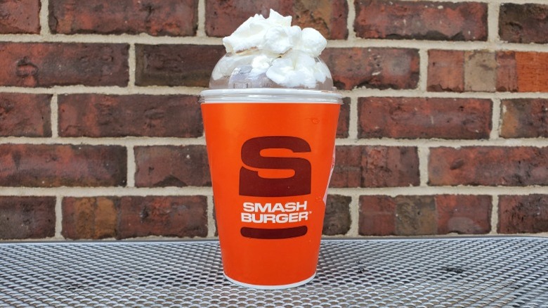 Smashburger chocolate milkshake with brick background