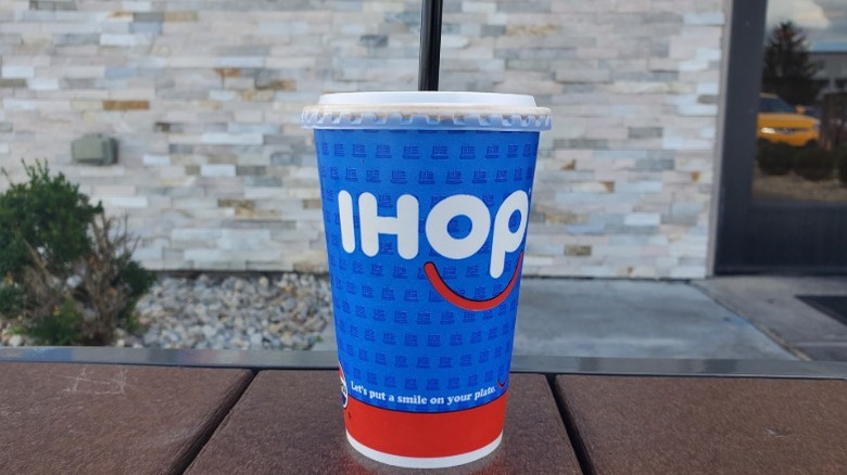IHOP chocolate milkshake with outdoor stone wall background