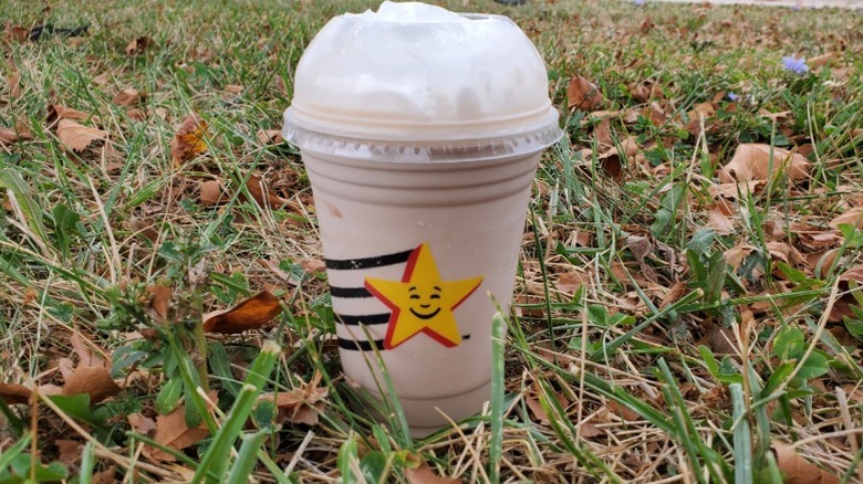 Hardee's chocolate milkshake in grass