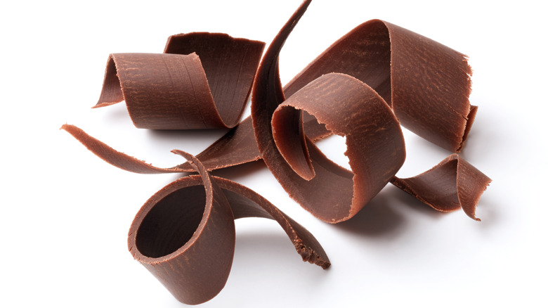 Chocolate curls on white surface