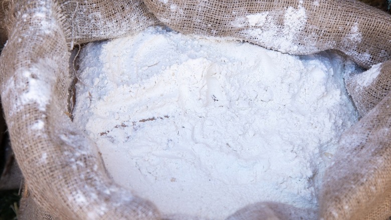 white flour in a rustic burlap sack