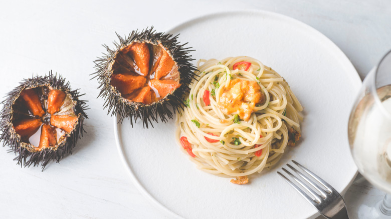 Pasta with sea urchins, and two sea urchins alongside