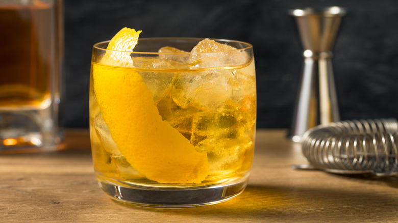 Rusty nail cocktail with lemon garnish