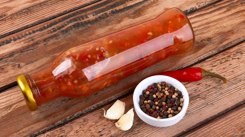 bottle of hot sauce on a wooden surface