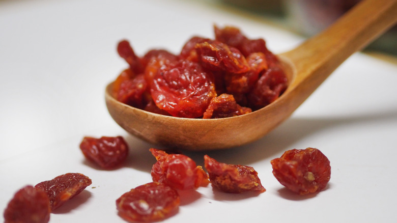 Sun-dried tomatoes in a wooden spoon
