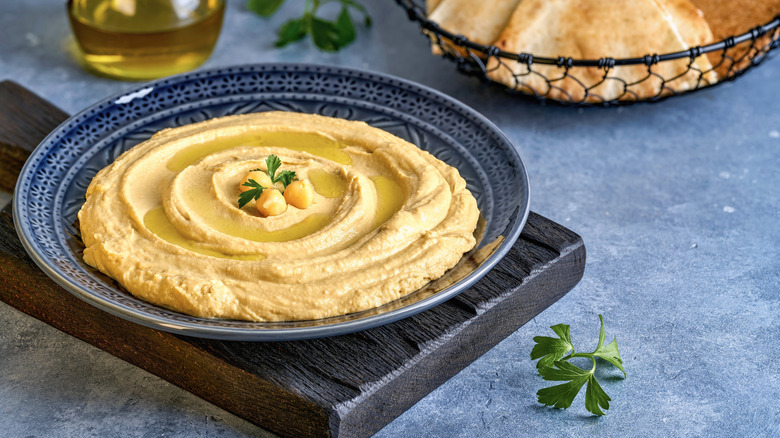 Hummus in a bowl with garnish