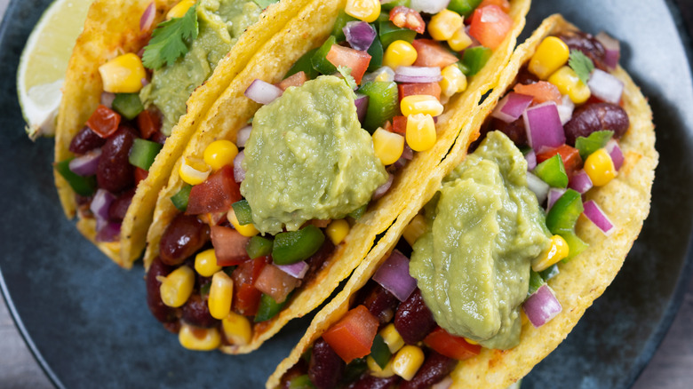 Bean tacos with guacamole and corn