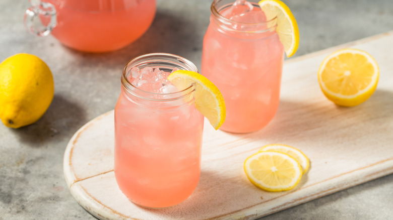 Two mason jar glasses of pink lemonade