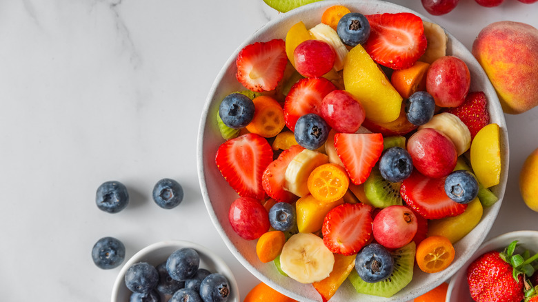 Variety of cut-up fruit in a white bowl