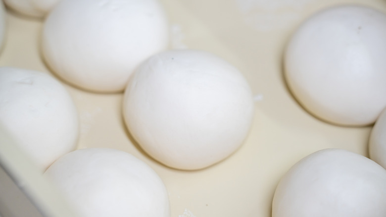 Balls of freshly made dough on baking paper