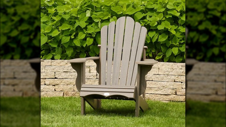 A light brown Adirondack chair in a garden