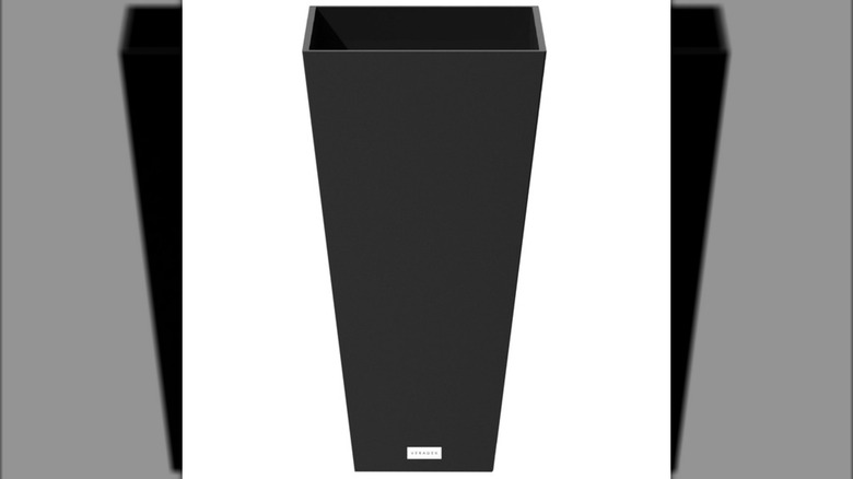 A tall black empty planter