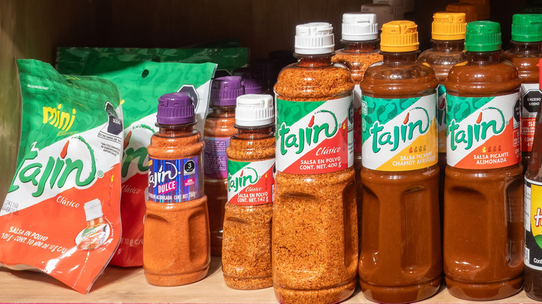 Bottles of Tajín seasoning and sauce on a shelf at a store